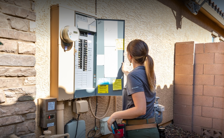 Home Inspector Jen Boekenoogen checking an electrical box